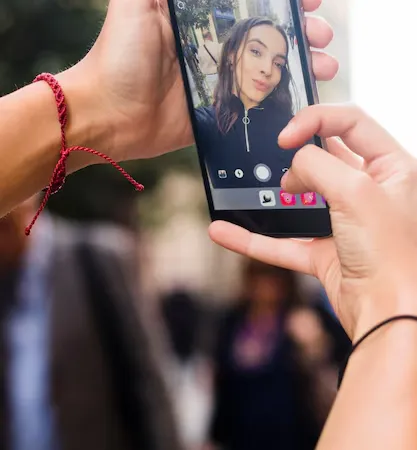 Person watching a live video on a mobile phone