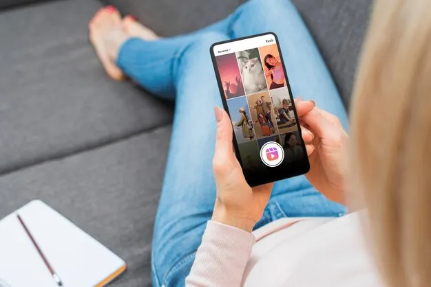 Woman holding a smartphone and watching video reels.