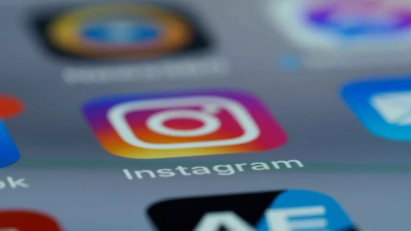 A smartphone screen displays the Instagram logo