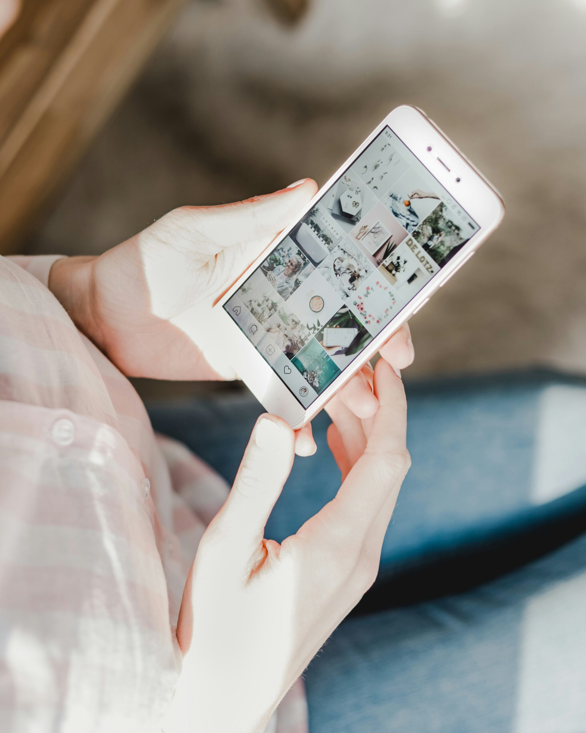 A person holding a phone and looking at a photo on the Instagram app.