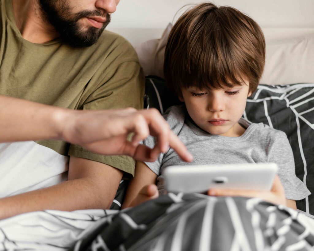 Father and son use tablet